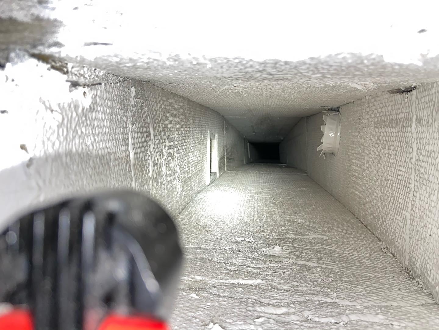 HVAC technician cleaning air ducts in residential South Florida home