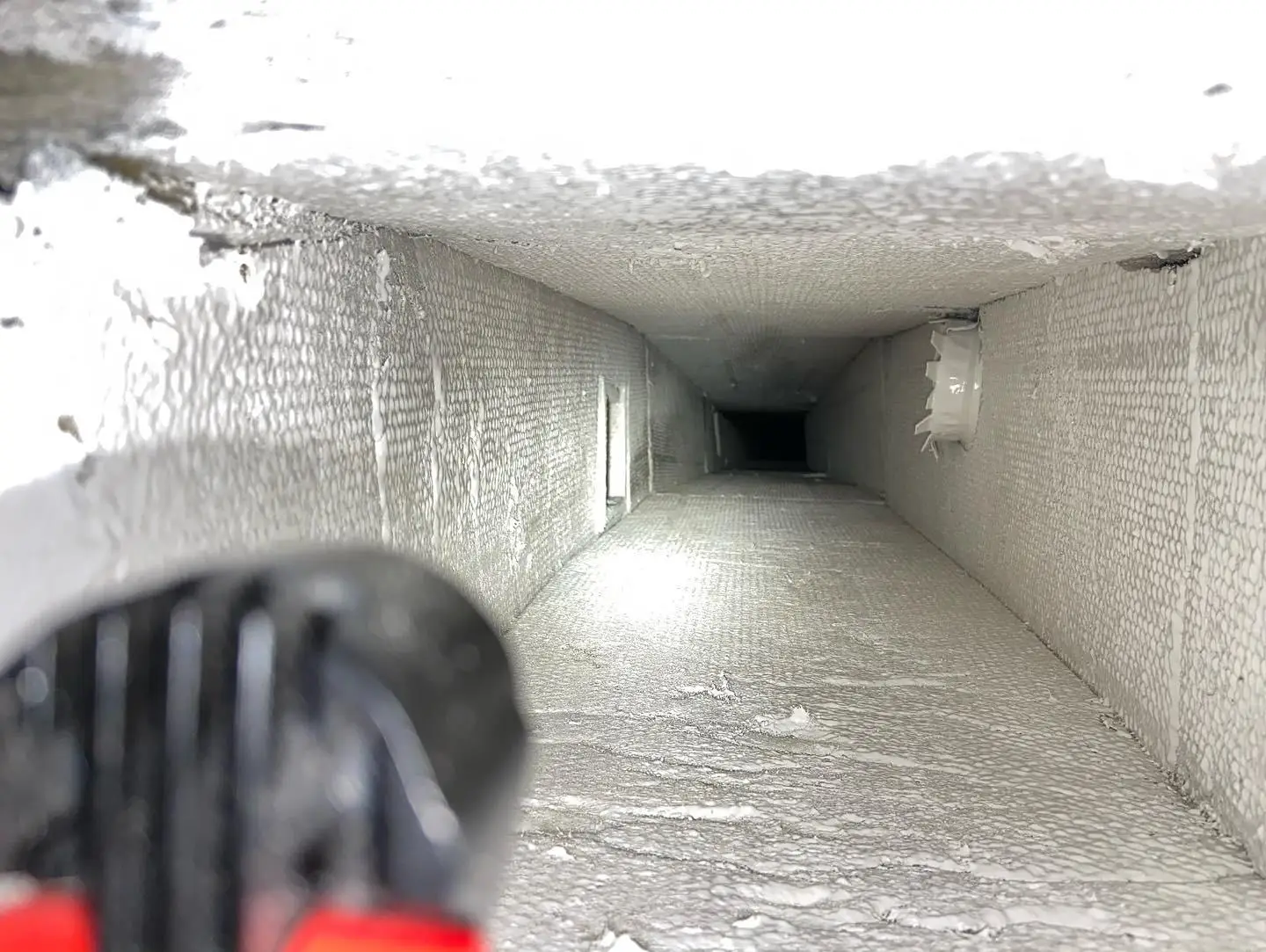 HVAC technician cleaning air ducts in residential South Florida home